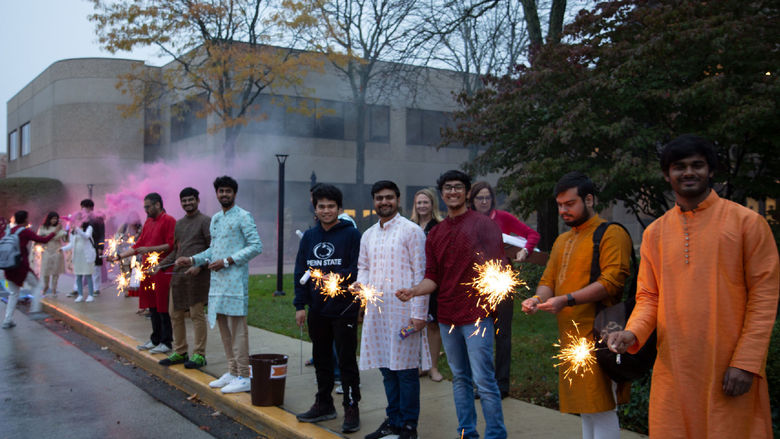 Students dressed up for Diwali lighting sparklers and firecrackers
