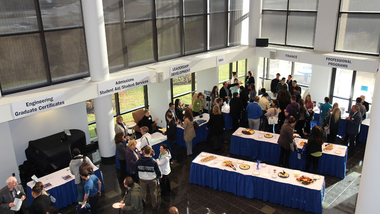 People talking at tables at a Penn State Great Valley Open House