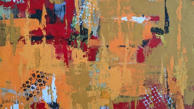 An abstract painting in reds and oranges
