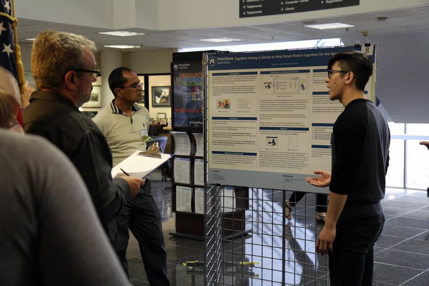 Engineering student presenting research to judges
