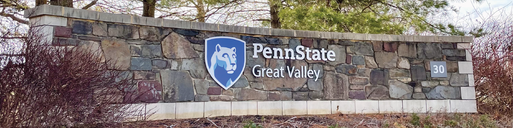 Photo of Penn State logo on a stone wall