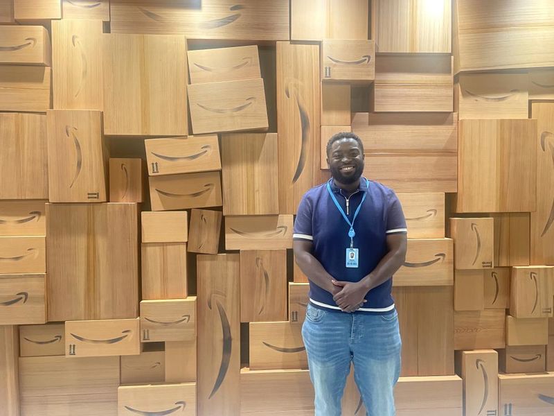 An intern stands in front of a display at Amazon in Seattle  