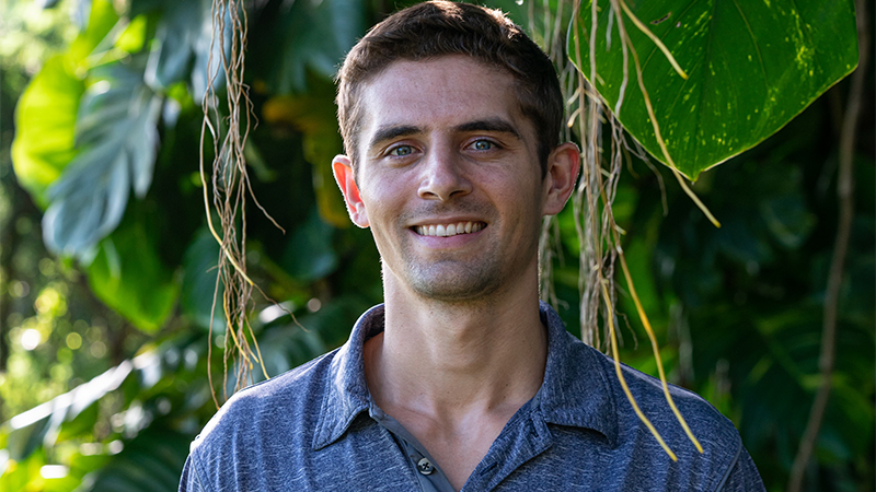 Paul Minninger stands in front of plants