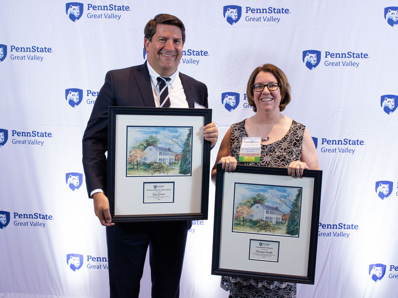 Gary Generose and Annamarie Walter holding award plaques