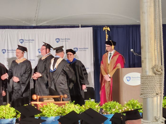 Jason Herman shaking hands with Carl Woodin at commencement