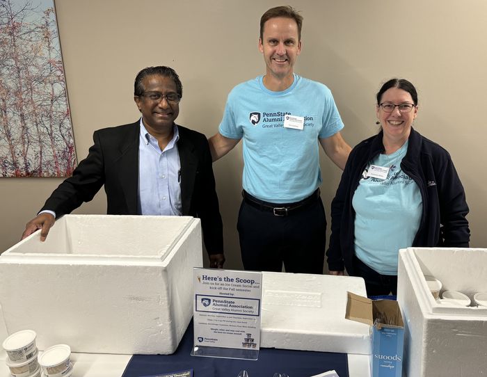Great Valley alumni society members serve Berkey Creamery ice cream at an event.