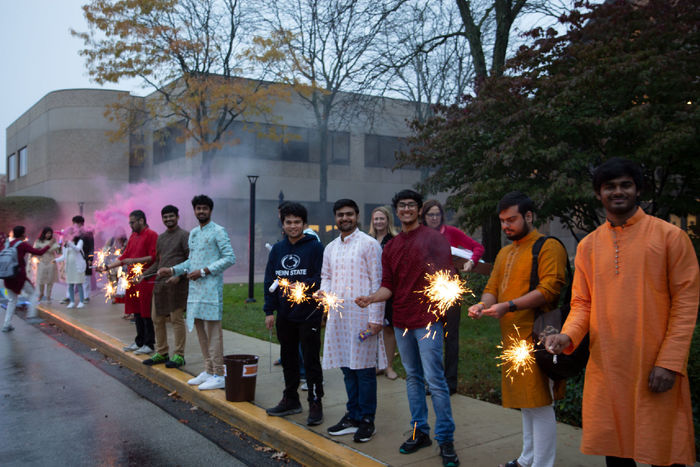 Students dressed up for Diwali lighting sparklers and firecrackers