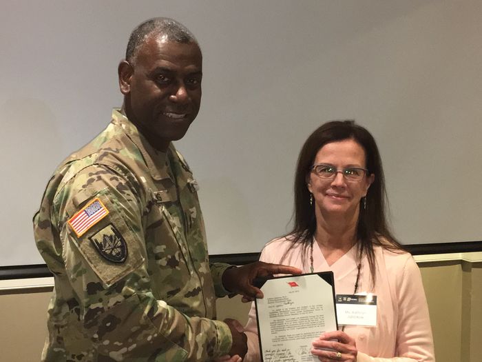 Major General Cedric Wins presenting Kathryn Jablokow with a commendation