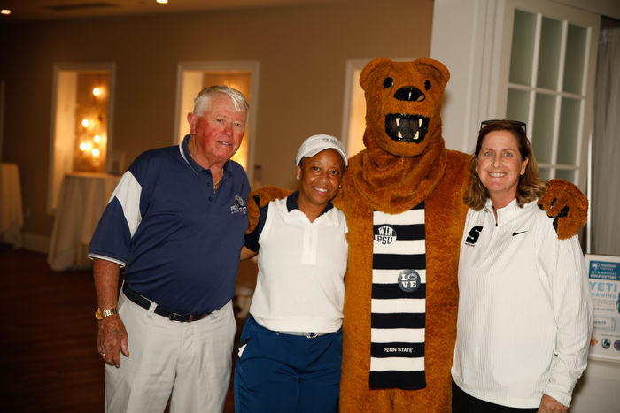 The Nittany Lion mascot poses with three attendees at the Penn State Great Valley golf outing.