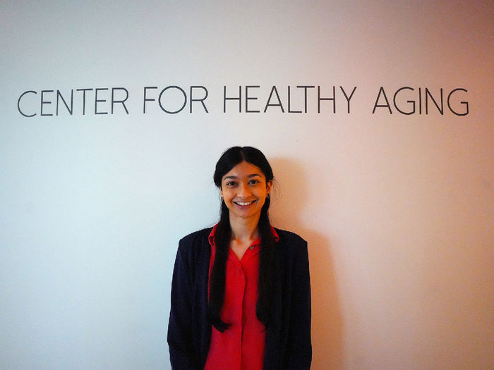 woman standing in front of Center for Healthy Aging sign