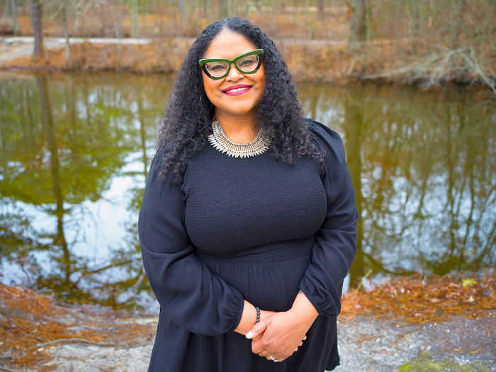 person standing in front of pond