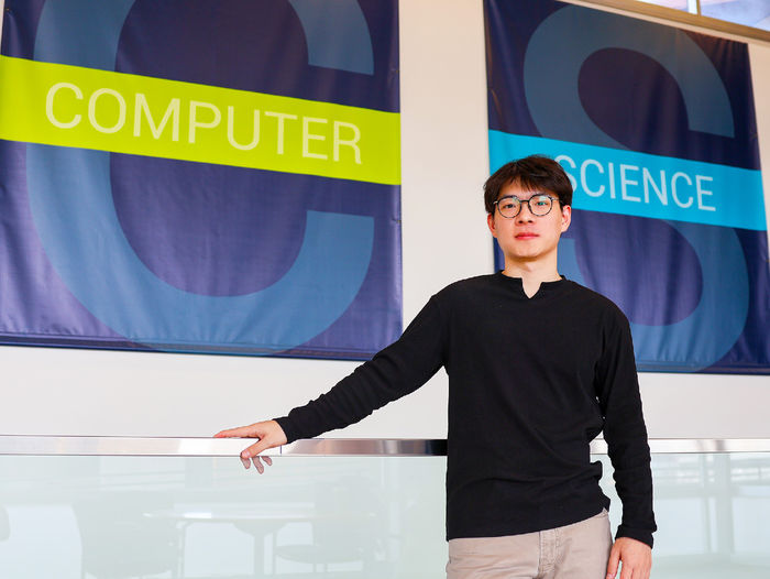 person standing in front of computer science and engineering sign