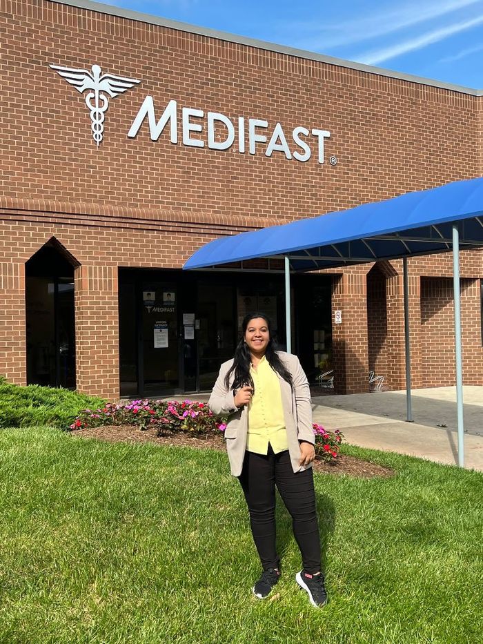 Vani Chaudhary standing in front of the Medifast building