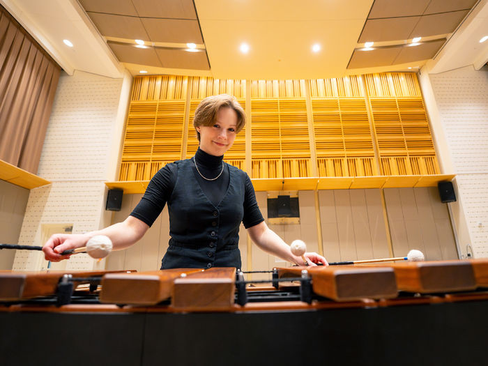 woman playing percussion instruments