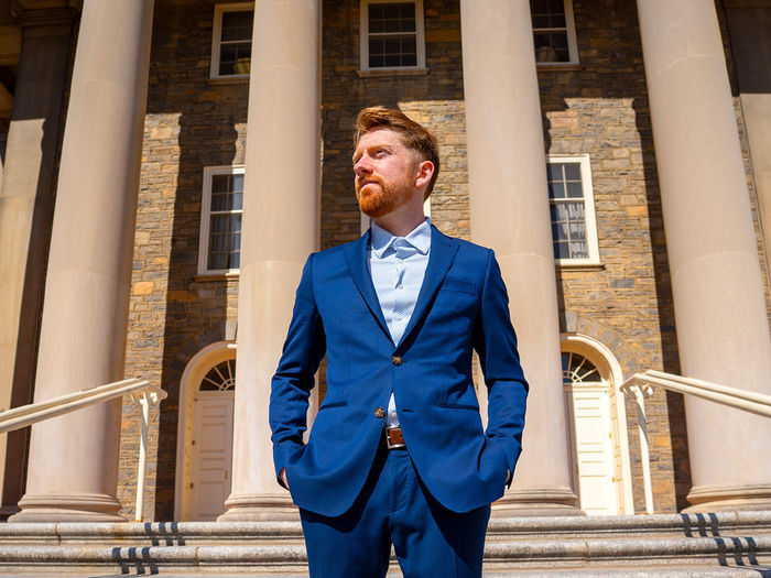 person standing on steps of Old Main