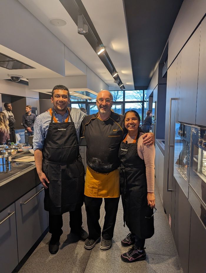 Three people standing in the Gaggenau kitchen