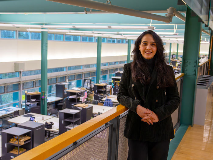 woman standing at railing in architecture studio building