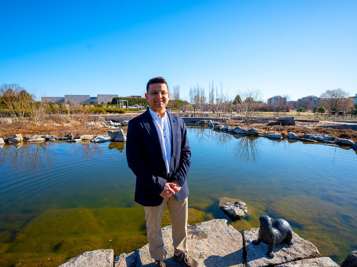 person standing in front of pond