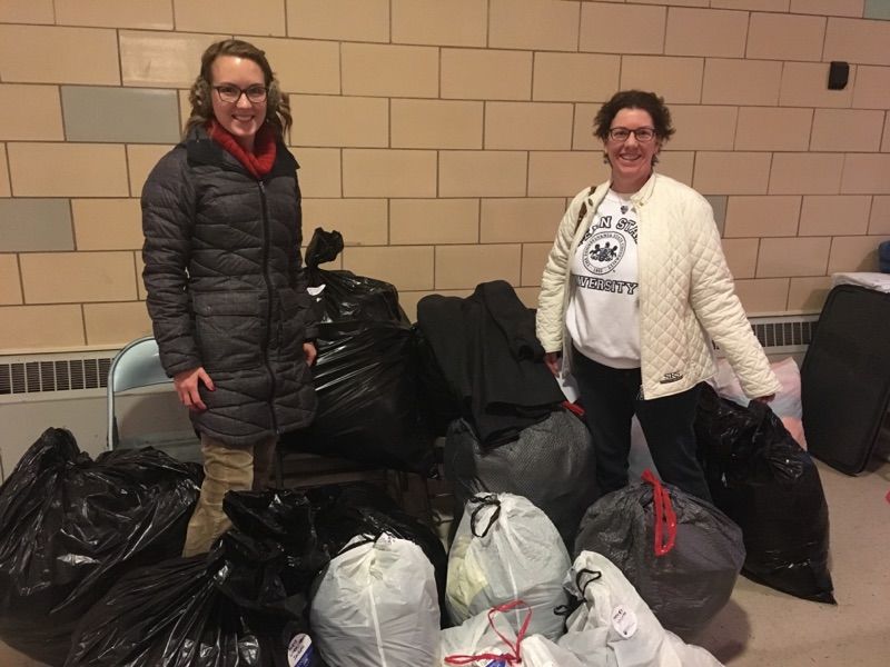 Photo of Great Valley Alumni Society members with bags of items collected through coat drive