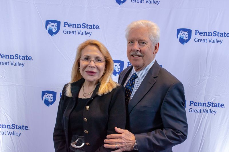 Drs. Michael and Madlyn Hanes standing in front of a Penn State Great Valley backdrop