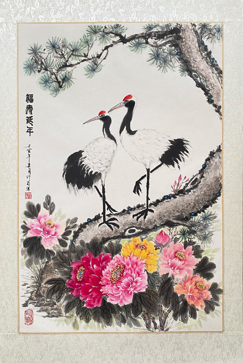 A painting of two birds on a tree