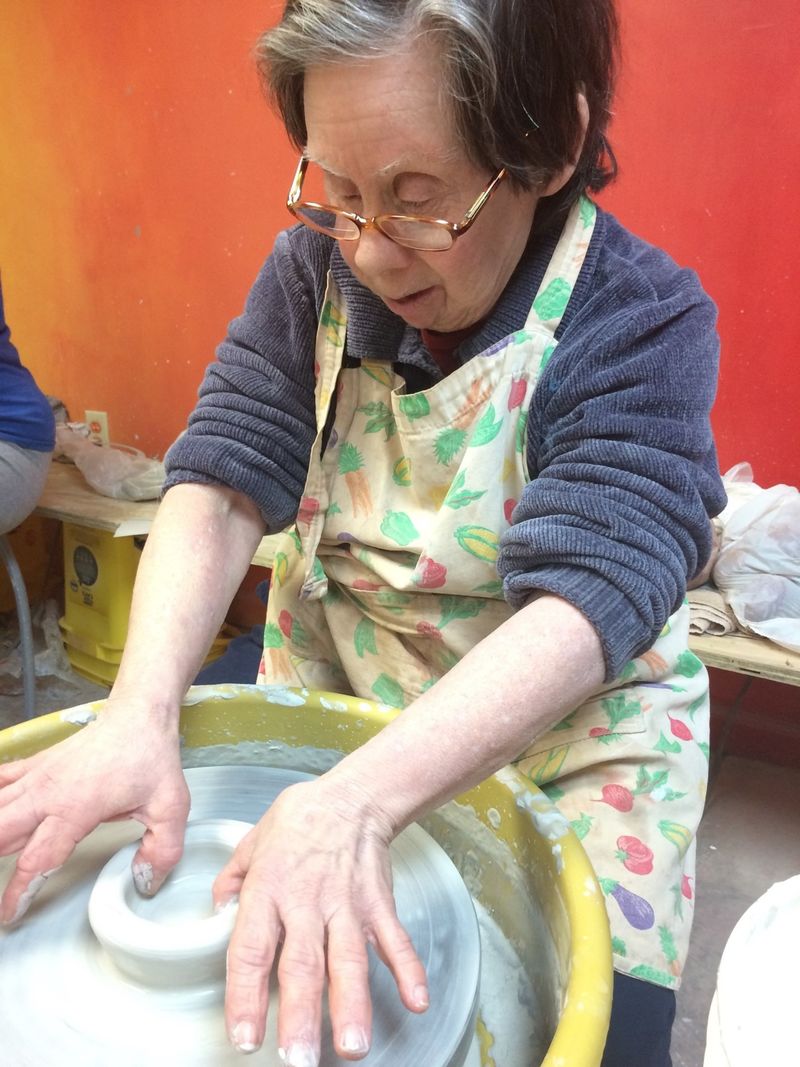 A woman working at a pottery wheel