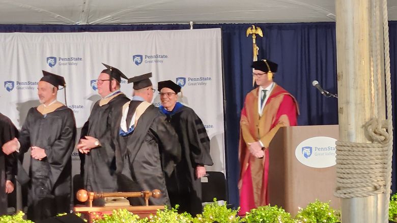 Jason Herman shaking hands with Carl Woodin at commencement