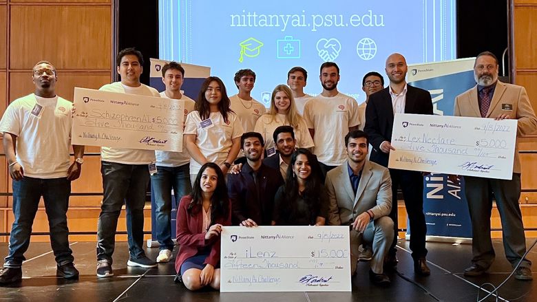 Students holding large checks.