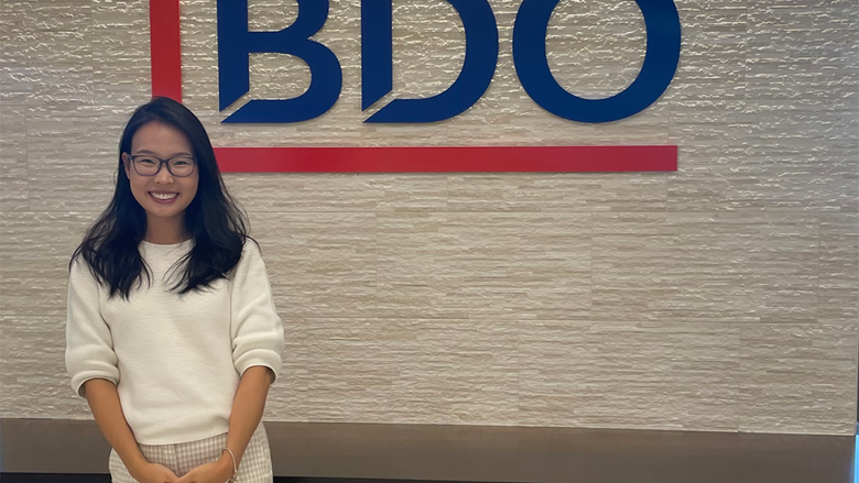 Bolortungalag Mijiddorj standing in front of a wall with the BDO logo