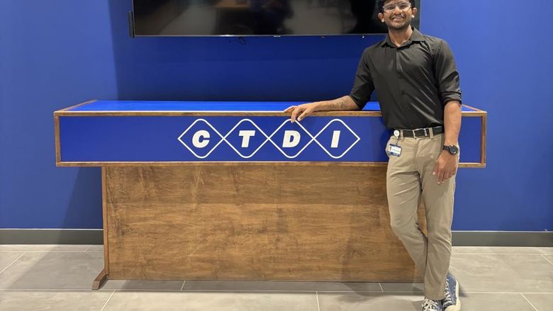 A person stands in front of a table that reads "CTDI"