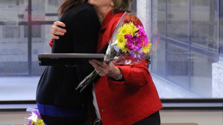 Two women hugging each other at the presentation of an award