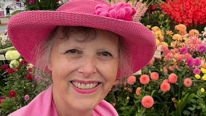 Jenny Rose Carey in front of flowers