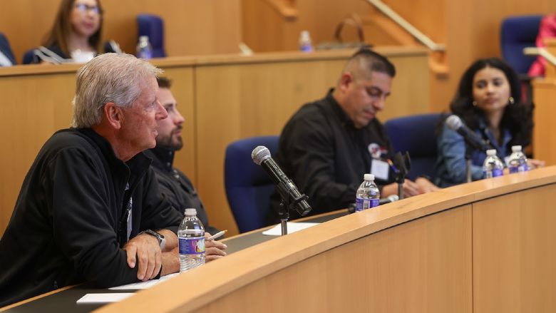 people sitting at table in auditorium