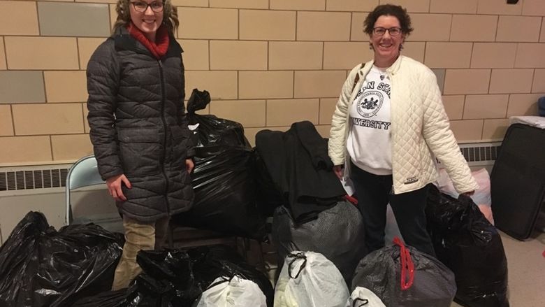 Photo of Great Valley Alumni Society members with bags of items collected through coat drive