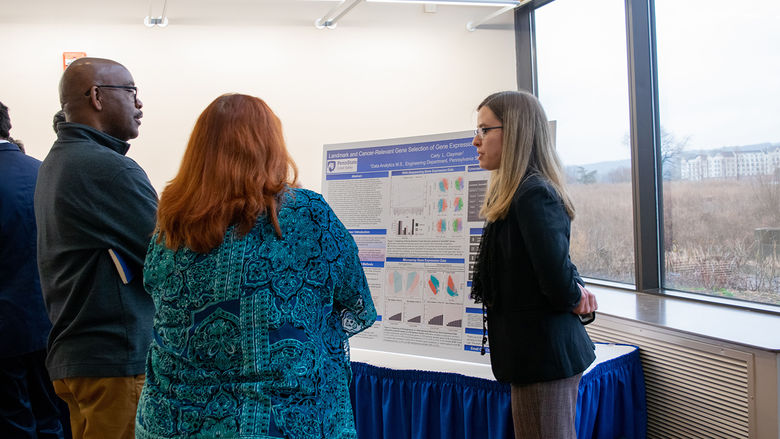 A student explaining her research to judges