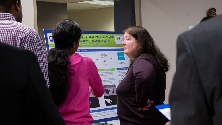 A student explaining her research to a judge