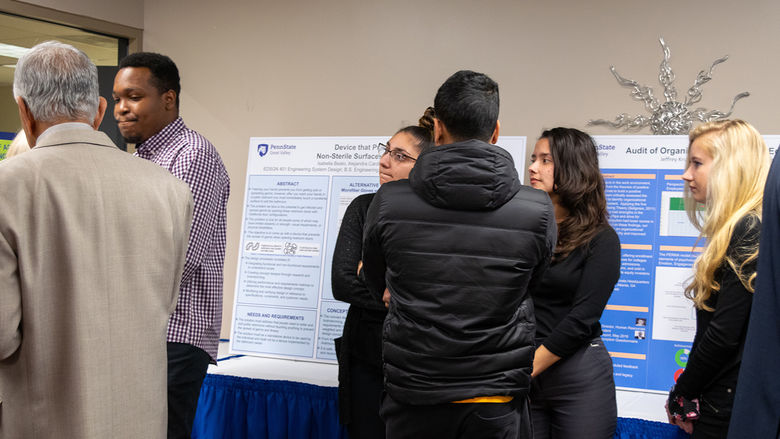 Students watch another group present their research