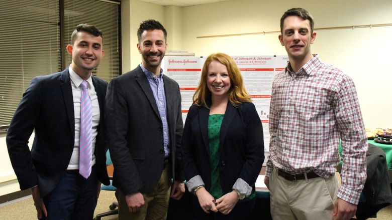 Penn State Great Valley graduate students stand in front of their audit poster