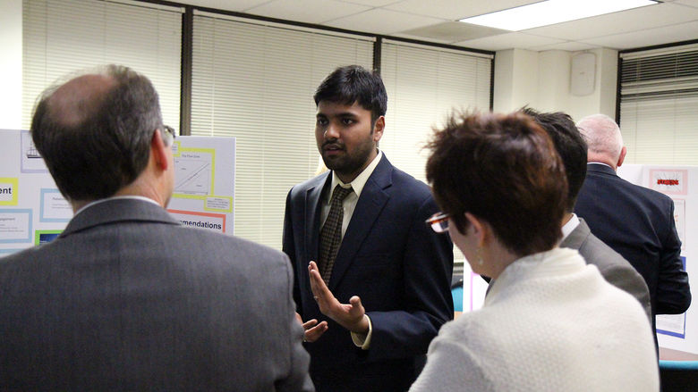 MBA student Kaushik Krishnaswamy Kumar conversing with judges