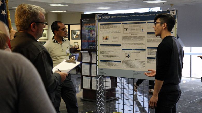 Engineering student presenting research to judges