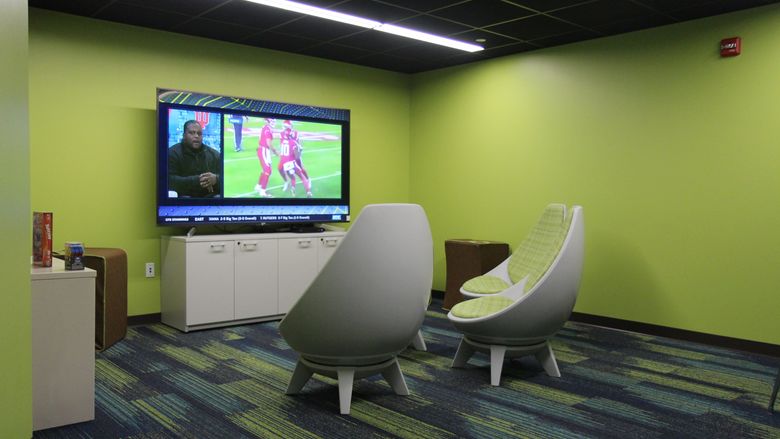 Gaming room with large tv and swivel chairs