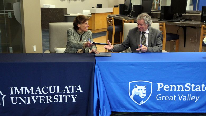 Barbara Lettiere, president of Immaculata University, signing an agreement with Penn State Great Valley Chancellor Jim Nemes at the Great Valley campus