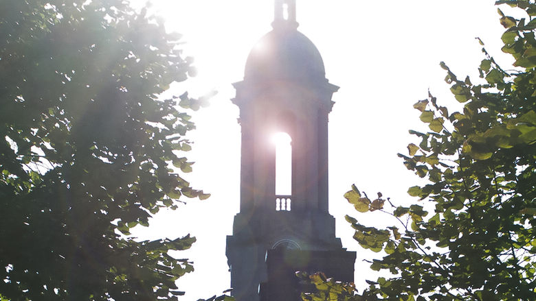 Sun streaming through Penn State's Old Main bell tower