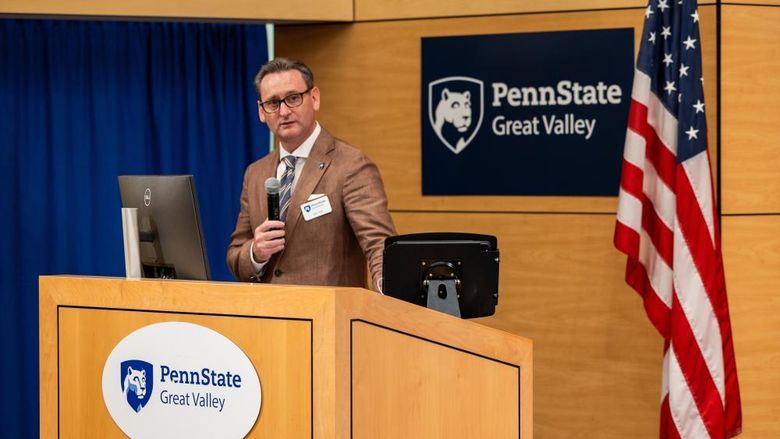 Professor and chancellor Colin J. Neill speaks at a podium at Penn State Great Valley