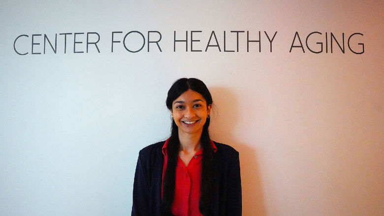 woman standing in front of Center for Healthy Aging sign