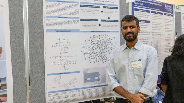 Student researcher Ameya Talatule stands in front of his research poster on freight transportation resilience