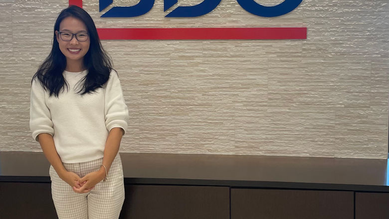 Bolortungalag Mijiddorj standing in front of a wall with the BDO logo