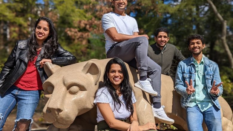 iLenz team members sitting in front of the Nittany Lion Shrine