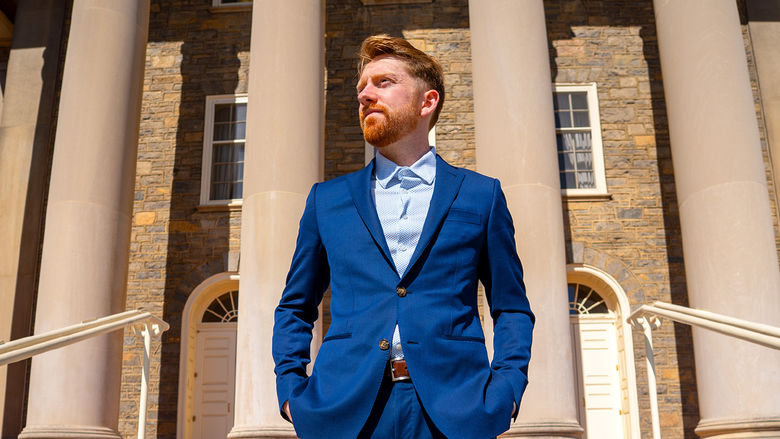 person standing on steps of Old Main