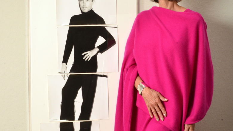 Lesley Frowick posing with photo of Halston